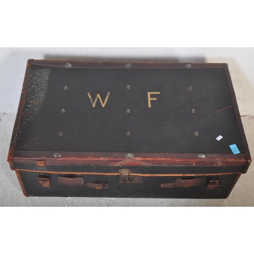 1256 - An early 20th century black leather steamer type travel trunk with white stencilled initials to lid ... 