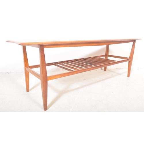 1272 - A vintage retro mid 20th century teak Ercol style coffee table. The coffee table having having a rec... 