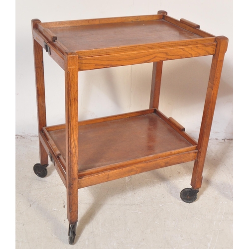 1279 - Two retro vintage 20th century oak drinks trolleys on castors. The lot to include a metamorphic oak ... 