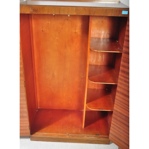 1283 - Wilton Furniture - An early 20th century circa. 1930's Art Deco era walnut bachelors wardrobe and dr... 