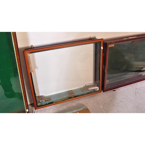 1286 - A collection of four vintage 20th Century wall mounted glazed front display cabinet. With teak body ... 