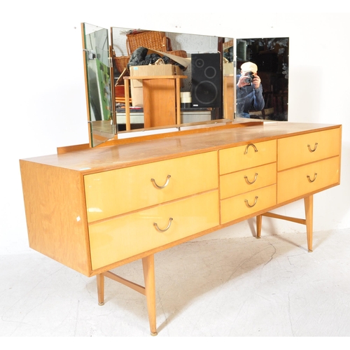 1287a - Mid century satin birch wood dressing table chest of drawers. Raised on tapering legs with a series ... 