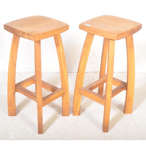 1287 - A good pair of contemporary solid oak bar stools in the Arts & Crafts manner. Each with squared and ... 