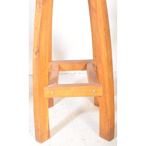 1287 - A good pair of contemporary solid oak bar stools in the Arts & Crafts manner. Each with squared and ... 