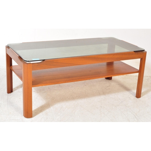 1297a - A collection of mid 20th Century teak wood coffee tables. One of them having a tile top in rectangul... 