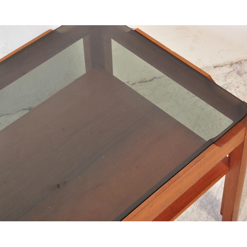 1297a - A collection of mid 20th Century teak wood coffee tables. One of them having a tile top in rectangul... 