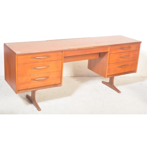 1314 - A vintage retro mid 20th century circa. 1960's teak writing desk having a central kneehole flanked b... 