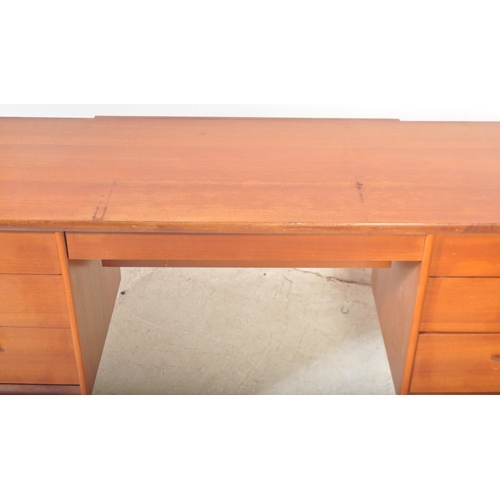 1314 - A vintage retro mid 20th century circa. 1960's teak writing desk having a central kneehole flanked b... 