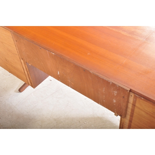 1314 - A vintage retro mid 20th century circa. 1960's teak writing desk having a central kneehole flanked b... 