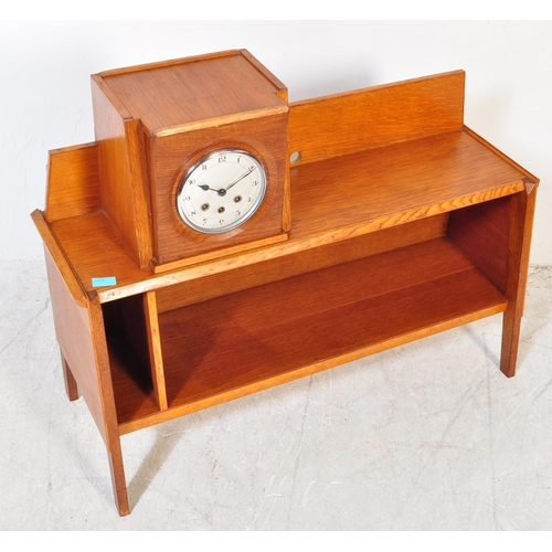 1317a - A retro 1950's mid 20th Century oak bookcase and clock combination. Of rectangular form with gallery... 