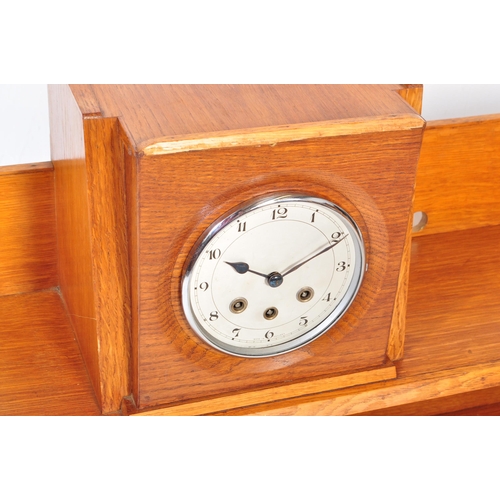 1317a - A retro 1950's mid 20th Century oak bookcase and clock combination. Of rectangular form with gallery... 