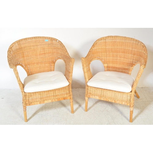 1325a - A pair of vintage 20th century wicker conservatory chairs having spoon back with raised elbow rests ... 