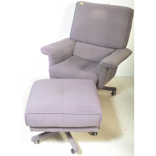 1326 - A retro vintage 20th century swivel armchair and matching footstool. Both being upholstered in a blu... 