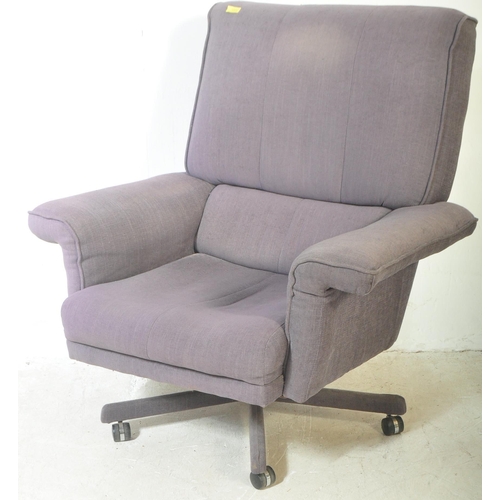 1326 - A retro vintage 20th century swivel armchair and matching footstool. Both being upholstered in a blu... 