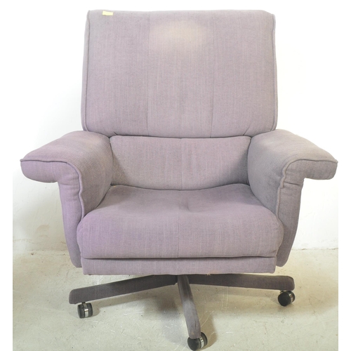 1326 - A retro vintage 20th century swivel armchair and matching footstool. Both being upholstered in a blu... 