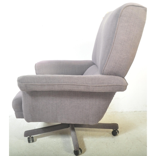 1326 - A retro vintage 20th century swivel armchair and matching footstool. Both being upholstered in a blu... 