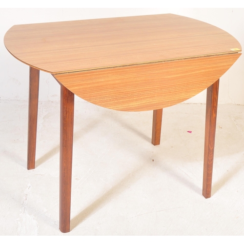 1329 - A retro vintage mid 20th Century drop leaf dining table. With oak veneer to top, with drop leaf exte... 