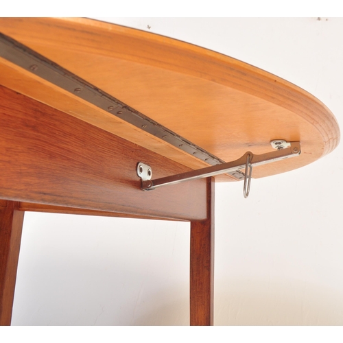 1329 - A retro vintage mid 20th Century drop leaf dining table. With oak veneer to top, with drop leaf exte... 