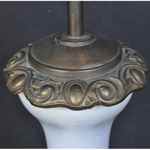 1337 - A vintage 20th century ceramic table lamp having double socket to top over a baluster shaped body de... 