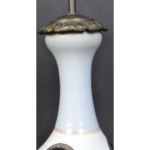 1337 - A vintage 20th century ceramic table lamp having double socket to top over a baluster shaped body de... 