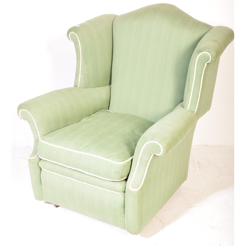 1347 - A retro vintage mid 20th century circa 1950s upholstered wingback armchair in pistachio green fabric... 