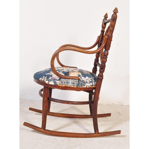 1354 - An Edwardian early 20th century bentwood rocking chair having finials atop over open back with woode... 