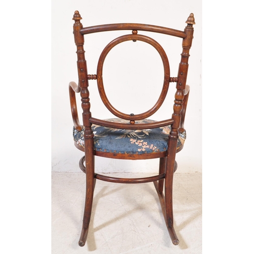 1354 - An Edwardian early 20th century bentwood rocking chair having finials atop over open back with woode... 