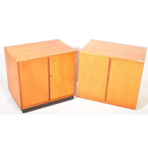 1358 - A pair of retro vintage 20th century teak wood record cabinets each having a straight top over twin ... 