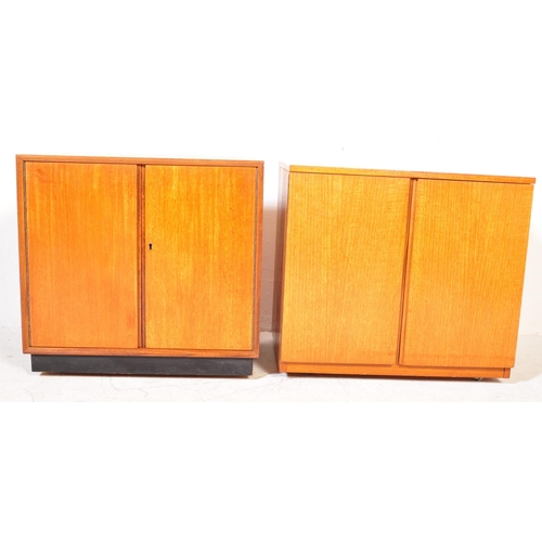 1358 - A pair of retro vintage 20th century teak wood record cabinets each having a straight top over twin ... 