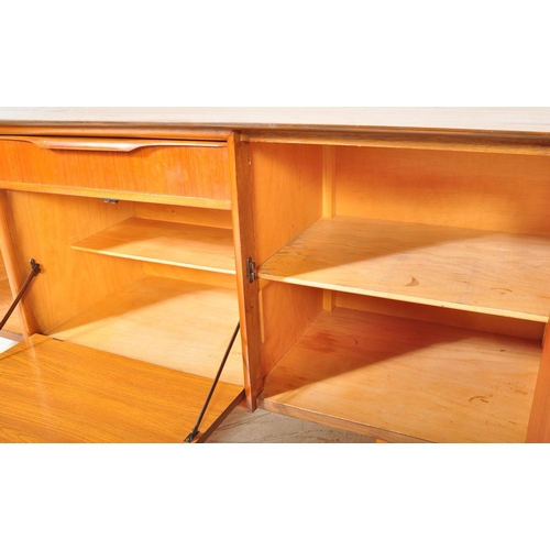 1364 - British Modern Design  - Mid century teak wood sideboard credenza. Raised on tapering legs with wide... 