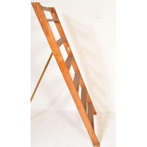 1368 - A 20th century vintage wooden ladder having metal hooks to top with vertical supports. Measures appr... 