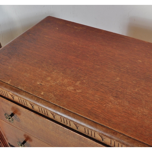 1379 - A 1940’s oak sideboard being raised on squared legs with a bank of three graduating drawers with bra... 