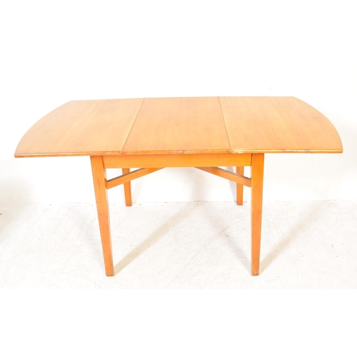 1384 - A vintage retro mid 20th century teak wood extending dining table having oval top over tapering squa... 