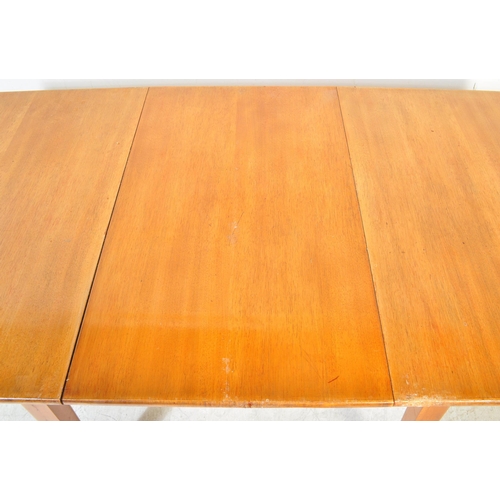 1384 - A vintage retro mid 20th century teak wood extending dining table having oval top over tapering squa... 