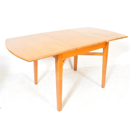 1384 - A vintage retro mid 20th century teak wood extending dining table having oval top over tapering squa... 