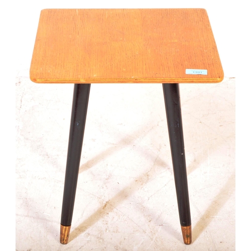 1391 - British Modern Design  - A Mid century teak wood coffee occasional table being raised on ebonised ta... 