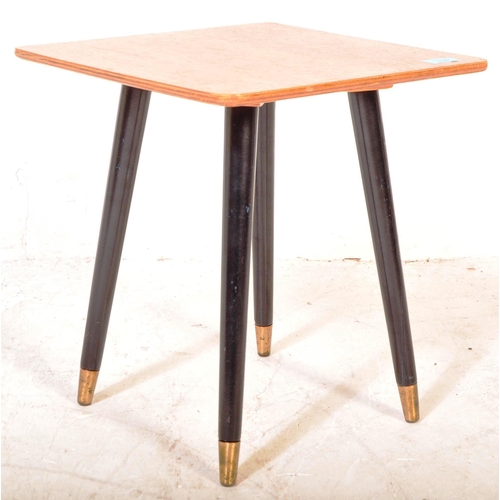 1391 - British Modern Design  - A Mid century teak wood coffee occasional table being raised on ebonised ta... 