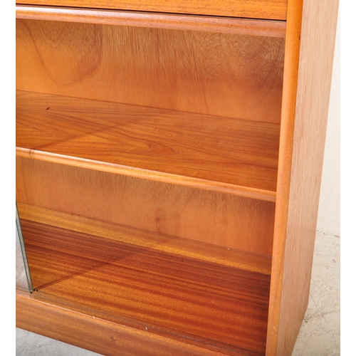 1393 - A vintage mid 20th Century teak bookcase unit. The bookcase having open recess to top above twin dra... 