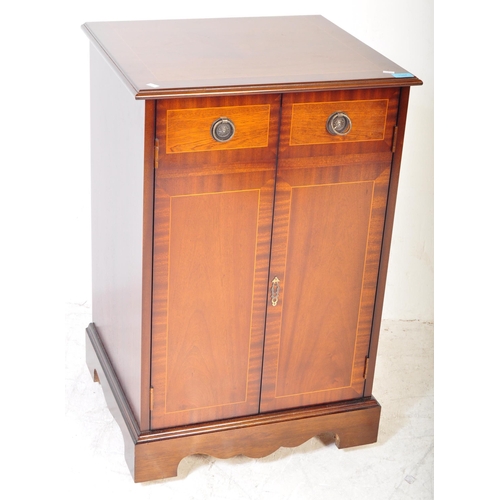 1394 - A Regency revival mahogany veneer music cabinet. The cabinet having satin wood inlay to the borders,... 