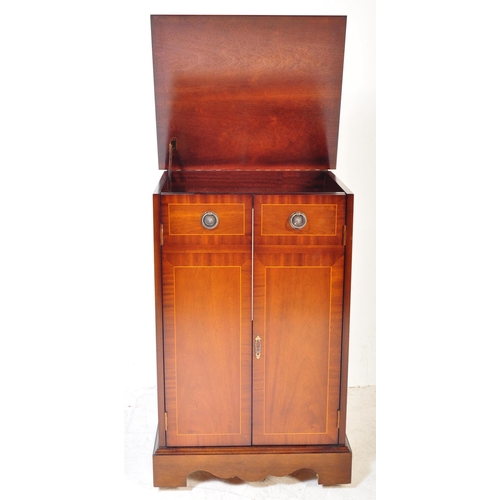 1394 - A Regency revival mahogany veneer music cabinet. The cabinet having satin wood inlay to the borders,... 