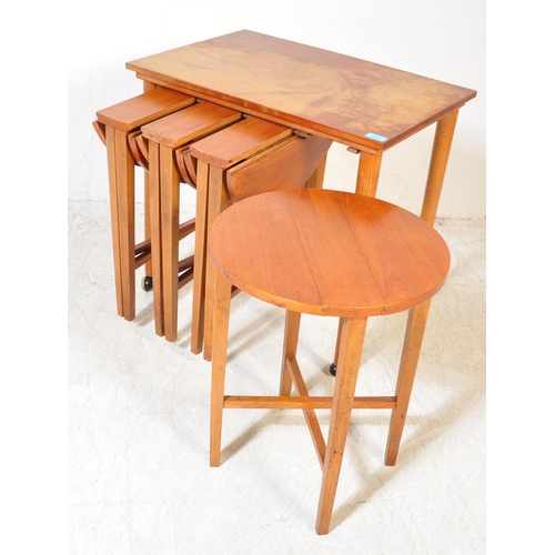 1395 - A retro 1970`s teak quartetto nest of tables, the large rectangular table raised on castors supporti... 