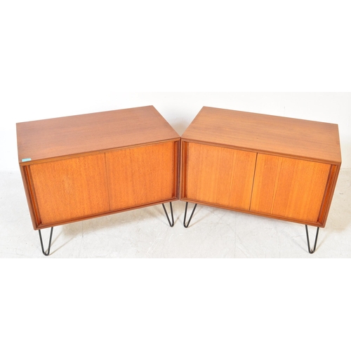 1397a - A pair of retro vintage mid 20th Century teak wood wall cabinets. Of rectangular form with twin slid... 