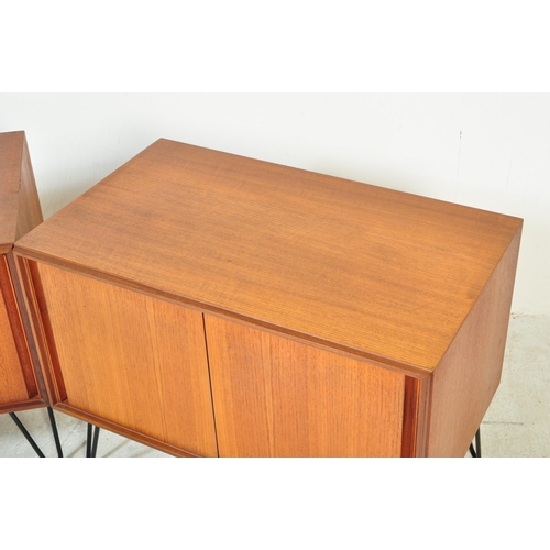 1397a - A pair of retro vintage mid 20th Century teak wood wall cabinets. Of rectangular form with twin slid... 