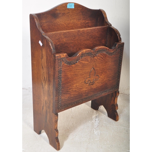 1408 - A 1920's oak Jacobean revival magazine canterbury stand rack with carved fleur de lys markings raise... 