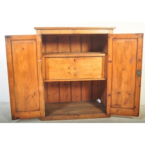 1422 - A Victorian 19th century pine school cupboard. Full length twin doors having white ceramic handle an... 