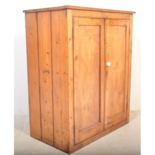 1422 - A Victorian 19th century pine school cupboard. Full length twin doors having white ceramic handle an... 