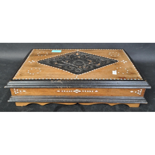 1437 - A vintage 20th century ebonised wooden desk top box with mother pearl inlaid. The case having a intr... 