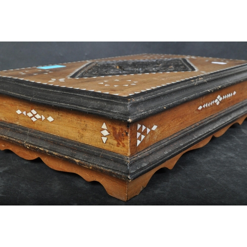 1437 - A vintage 20th century ebonised wooden desk top box with mother pearl inlaid. The case having a intr... 