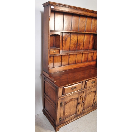 1439 - Ipswich oak George III 18th century revival dresser. Raised on plinth base with short drawers over c... 