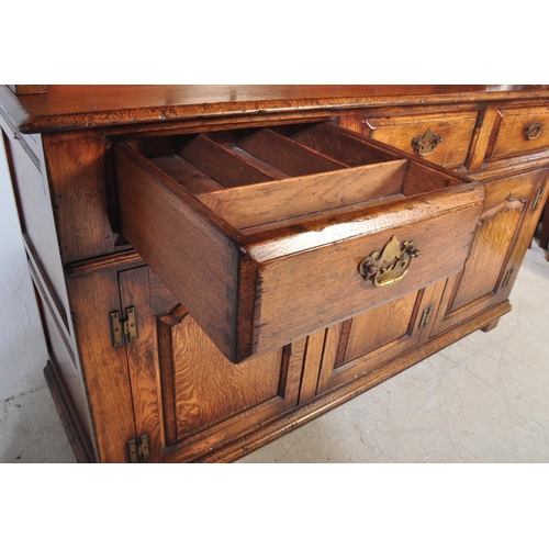 1439 - Ipswich oak George III 18th century revival dresser. Raised on plinth base with short drawers over c... 